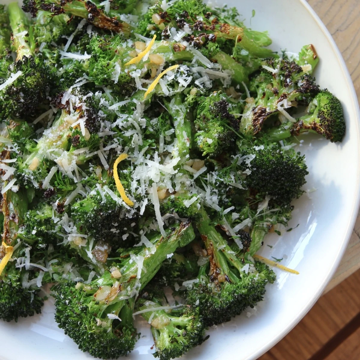Golden-brown Simple Garlic and Parmesan Roasted Broccoli speckled with Parmesan, ready to serve warm.