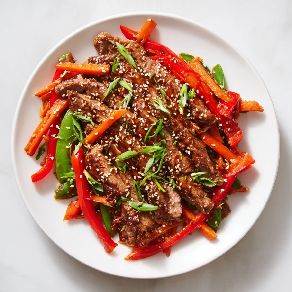 Sweet teriyaki pork stir-fry featuring glistening pork and colorful, crisp vegetables coated in savory sauce.