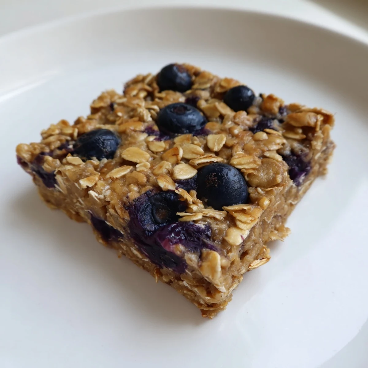 Delicious, homemade blueberry banana oatmeal protein bars offering a satisfyingly chewy, protein-packed bite.