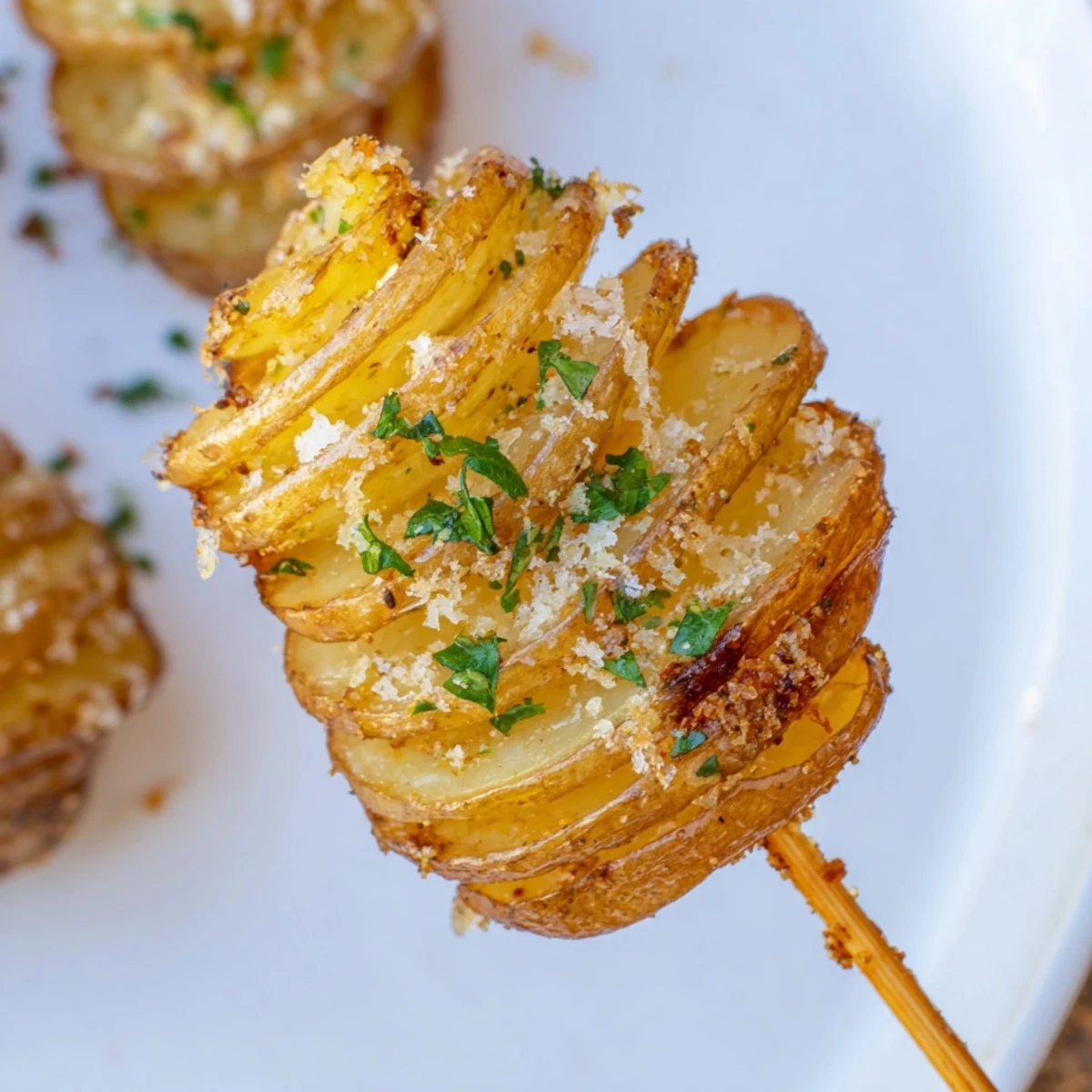 Golden-brown Tornado Potatoes on a skewer, perfect crispy snacks, seasoned and ready to eat.