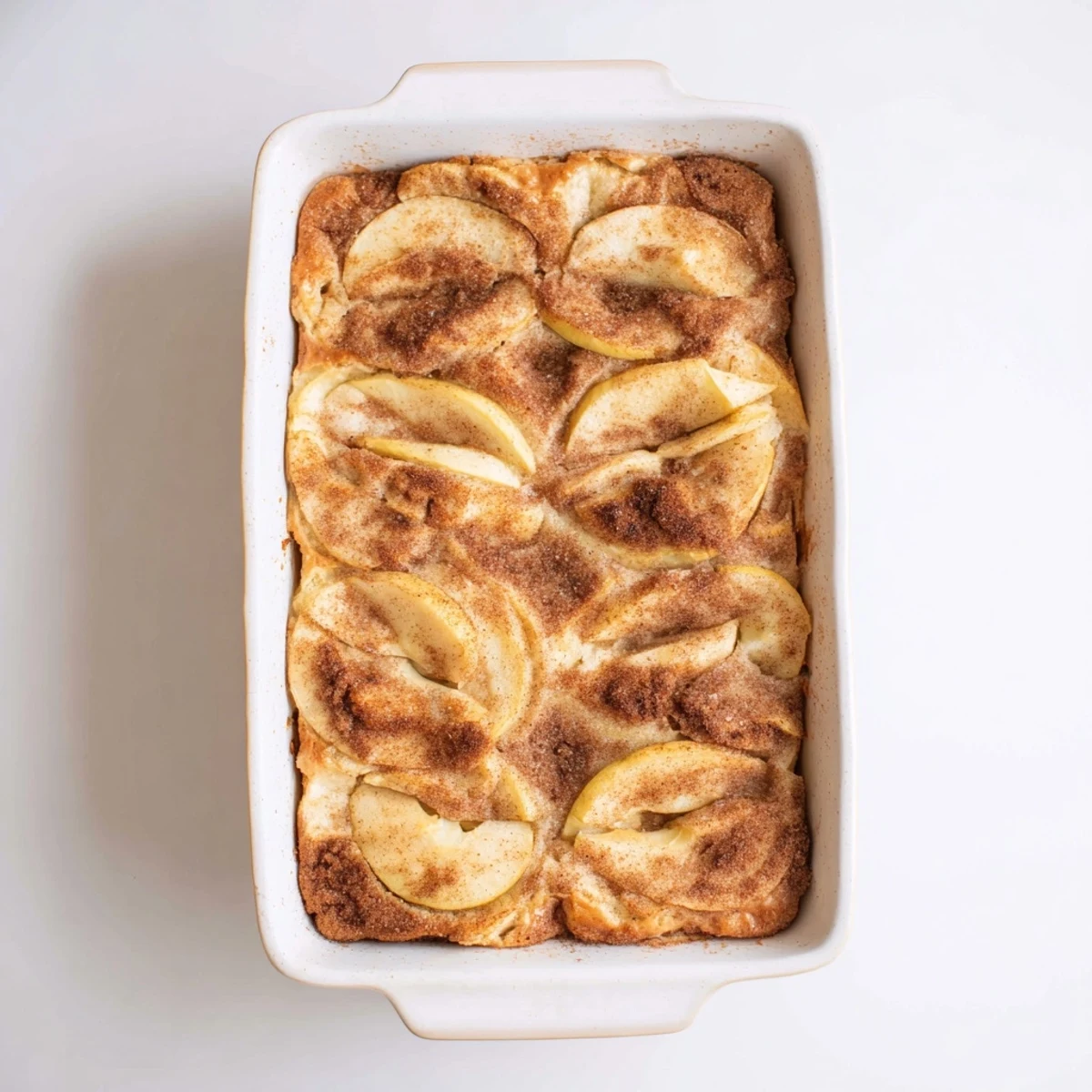 Golden Baked Apple Cake cooling on a rack, with a rich cinnamon aroma and juicy apples in a golden, soft crumb.