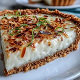 Visually, a refreshing Coconut Lime Tart ready to be garnished.