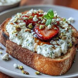 Close-up of Strawberry Honey Ricotta Toast with Pistachios, calling for a delightful morning bite.