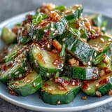 Crisp smashed cucumber salad, glistening with sesame oil, perfect for a light appetizer.