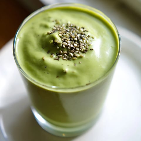 Creamy Spinach Avocado Smoothie with frozen mango, a vibrant green, delicious healthy drink.