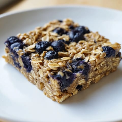 Golden-baked blueberry banana oatmeal protein bars, a healthy breakfast or snack option for everyone.