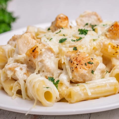 A close-up of a steaming Chicken Alfredo Bake, hinting at its comforting, rich flavors.