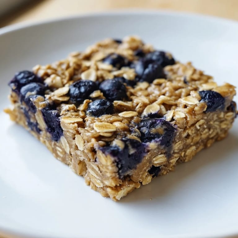 Golden-baked blueberry banana oatmeal protein bars, a healthy breakfast or snack option for everyone.