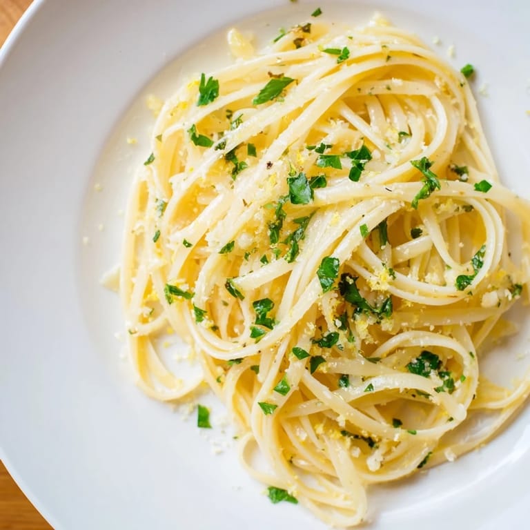 Close-up of creamy Garlic Butter Linguine, Parmesan cheese sprinkled, perfect for a cozy night.