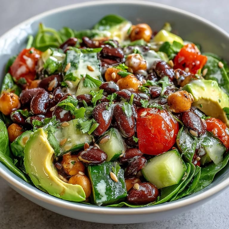 Serving suggestion for Three-Bean Power Bowl: garnished with toasted pumpkin seeds and cilantro alongside a warm quinoa base.